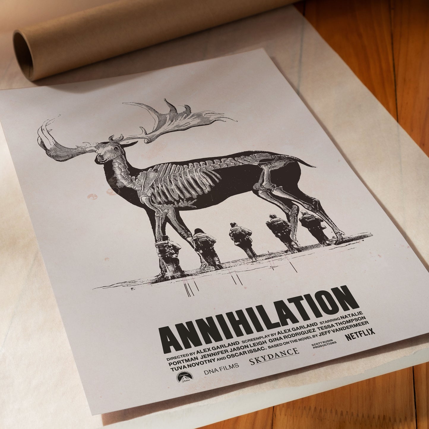 Movie poster for 'Annihilation' with a skeleton deer and four figures on a wooden surface.