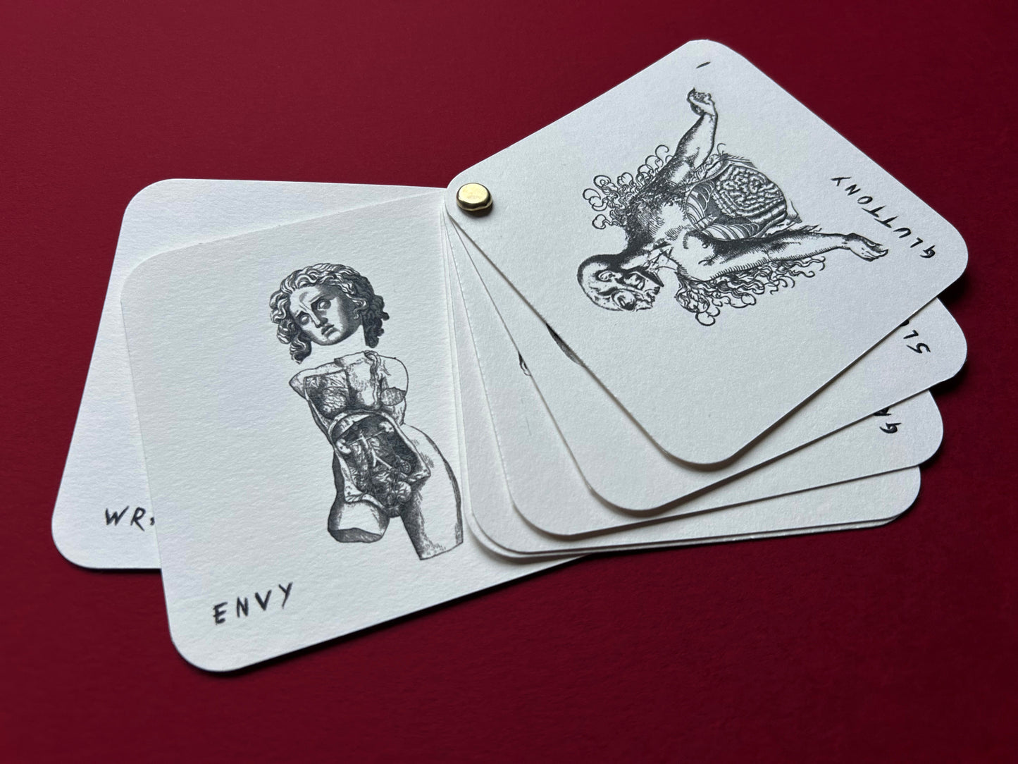 Set of tarot cards with black illustrations on a red background This limited edition Se7en print pack is a tribute to David Fincher’s iconic masterpiece. Each set includes three fine art prints, a seven mini print booklet, a small metronome card and a collector’s sticker. This is all handmade and printed by myself.