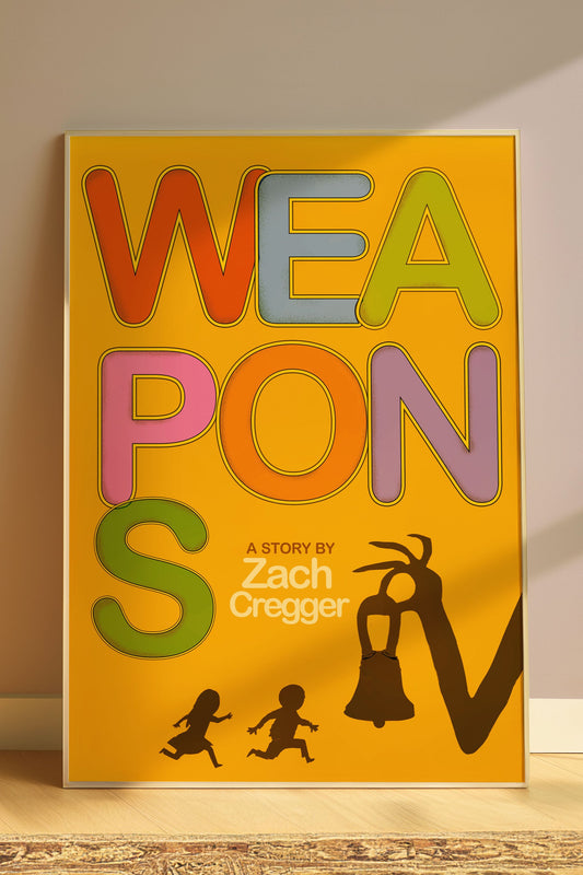 Book titled 'WEAPONS' by Zach Cregger with colorful text on a yellow background